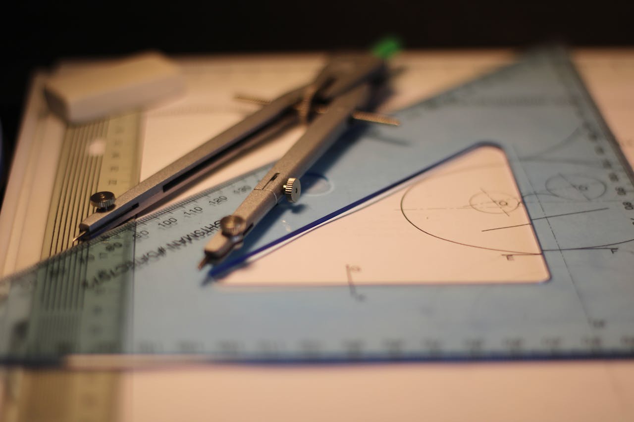 Mastering the First Impression: Your intriguing post title goes here Precision drafting tools including compass and set square on a sketchpad.