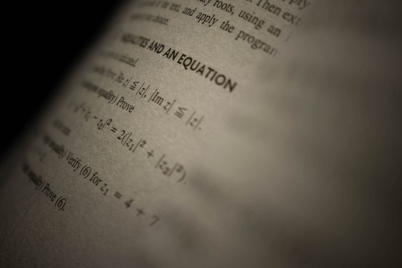 Crafting Captivating Headlines: Your awesome post title goes here Selective focus on a mathematics textbook page with complex equations and text.